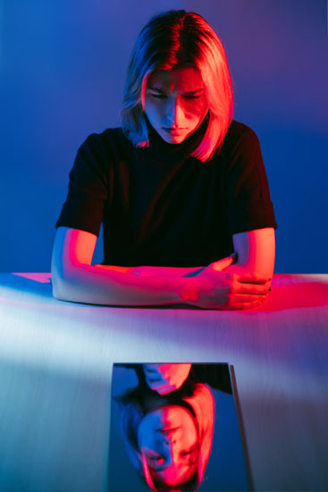 A person staring at their reflection in a device
