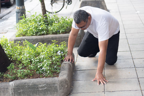 A person falling down on the sidewalk