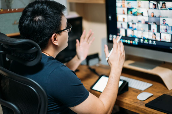 A person on a video meeting with their coworkers