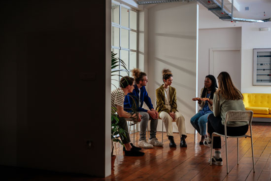 A group of people in a group therapy session