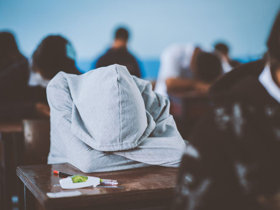 A student with his head laying on the desk