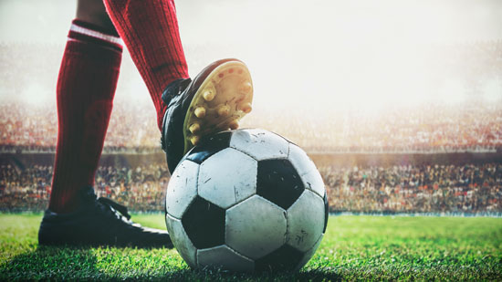 A picture of a soccer cleat on a soccer ball