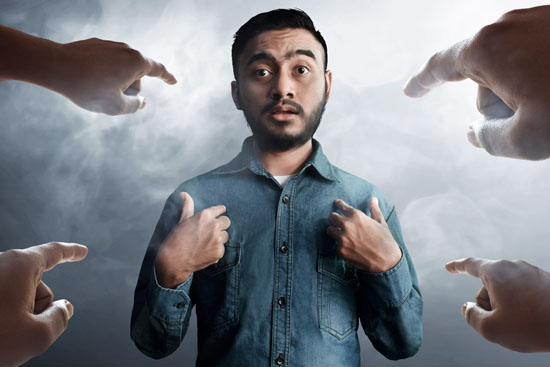 Four hands pointing to a man, who is also pointing to himself