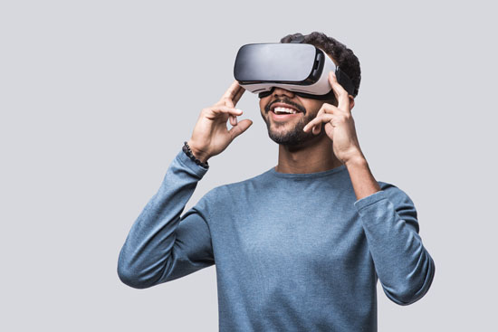 A person wearing a virtual reality headset and smiling