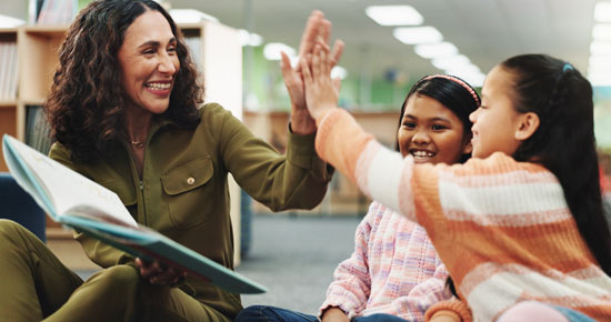 A picture of a student and teacher sharing a high five