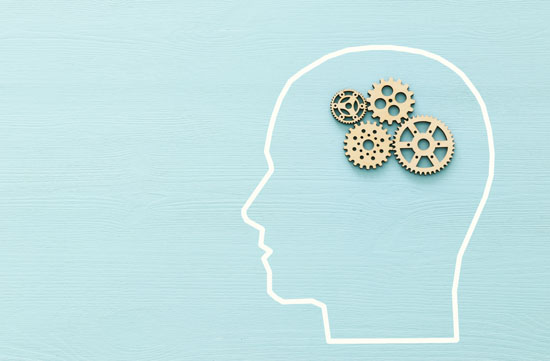 Image of an outline of a human head with gears as the brain