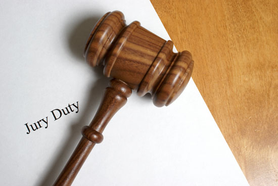 A picture of a gavel resting on a paper that says jury duty