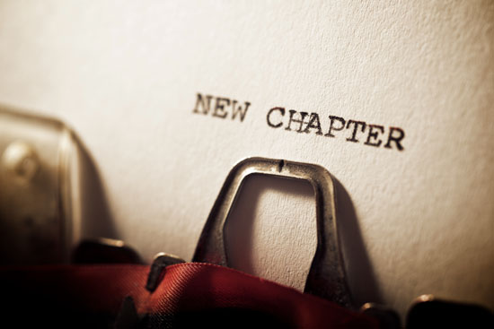 A typewriter with a page that reads 'New chapter'