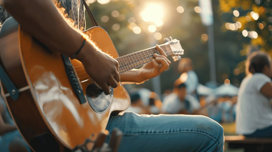 A person playing a guitar outdoors