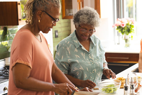 A younger woman and an older woman cooking together