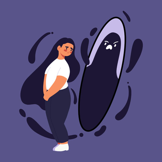 A person looking nervously behind her at her angry reflection in a mirror