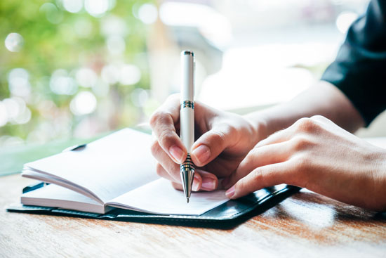 A person writing in a journal